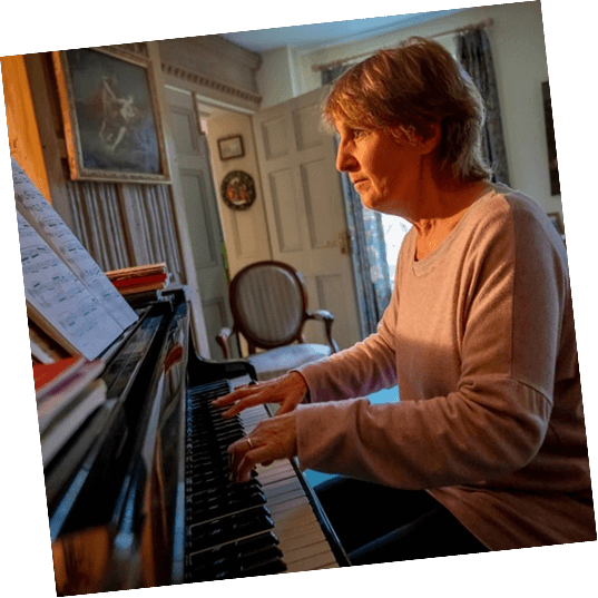 A senior reads sheet music while playing a scale,