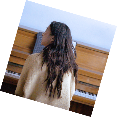 A young woman hones her technique on an acoustic piano during her weekly piano lessons in Pasadena.