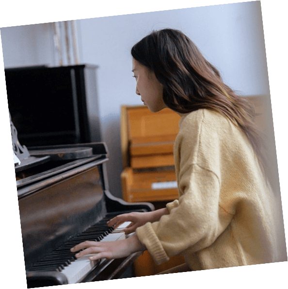 An adult student looks at sheet music during a piano lesson in Pasadena.